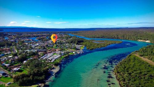a hot air balloon flying over a river at The Perfect Holiday Home in Sussex inlet