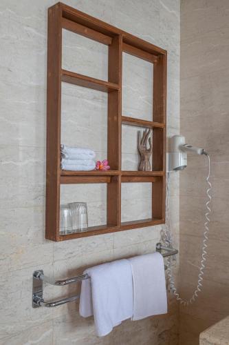 a bathroom with a towel rack and a window at Nusa Indah Candidasa in Candidasa