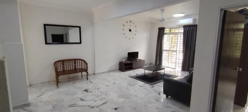 a living room with a couch and a chair at Saga Laguna Condo Homestay in Port Dickson