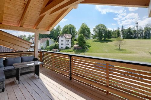 a balcony with a view of a house at Ferienwohnung Schwaiger Almblick in Bad Tölz