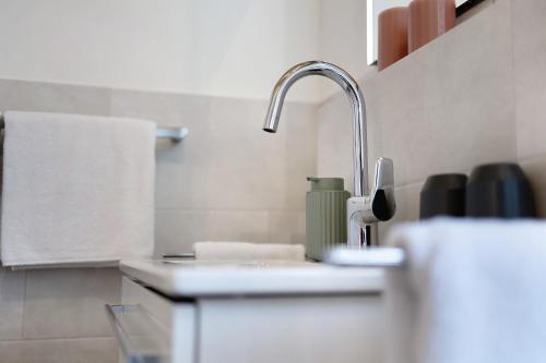 a white kitchen with a sink and a towel at Ferienwohnung Schwaiger Almblick in Bad Tölz