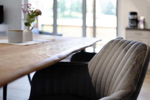 a dining room table with a chair in front of it at Ferienwohnung Schwaiger Almblick in Bad Tölz