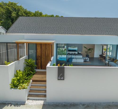 a house with a view of the backyard at Villa Mia Fulhadhoo in Fulhadhoo