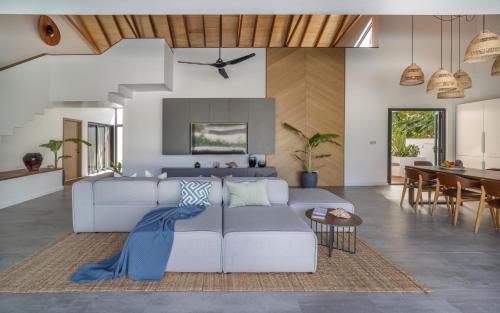 a living room with a couch and a table at Villa Mia Fulhadhoo in Fulhadhoo