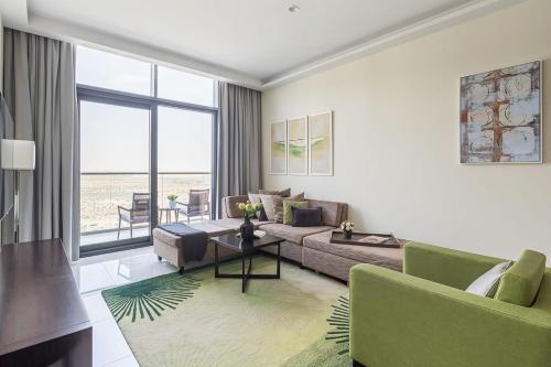 a living room with a couch and a table at Frank Porter - Damac Celestia in Dubai