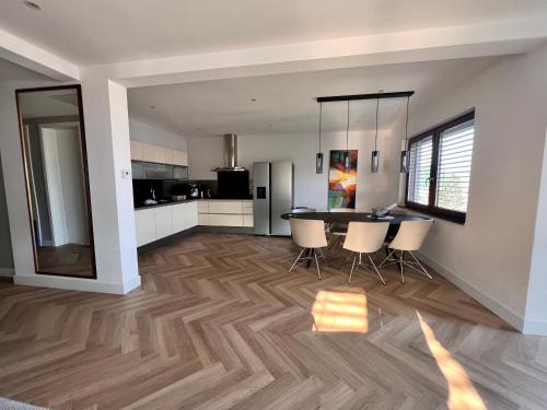 a kitchen and dining room with a table and chairs at The Penthouse Sarajevo in Sarajevo