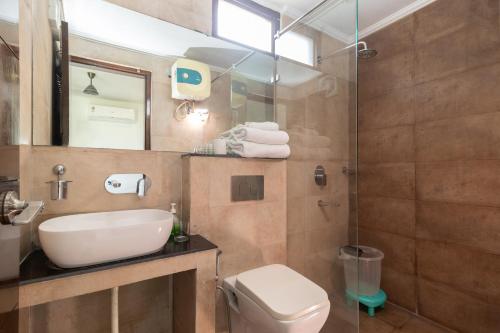 a bathroom with a sink and a toilet and a shower at Jasmine 3BHK by Wabi Sabi Stays with Private Balcony in Rishīkesh