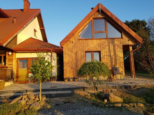 a wooden house with a pathway leading up to it at Dolina Biebrzy - Chata Flisaka in Wroceń