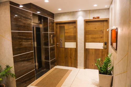 a bathroom with a shower with a glass door at Mezkar Residency in Alwaye