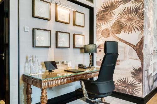 a home office with a desk and a chair at ITC Narmada, a Luxury Collection Hotel, Ahmedabad in Ahmedabad
