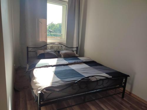 a bed in a small room with a window at Warsaw Apartment Iwona - all 45m2 - close to the centre in Warsaw