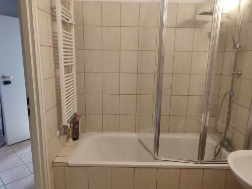 a bathroom with a shower and a tub at Warsaw Apartment Iwona - all 45m2 - close to the centre in Warsaw