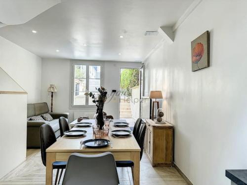 d'une salle à manger avec une table et des chaises dans le salon. dans l'établissement La Deauvilloise YourHostHelper, à Deauville