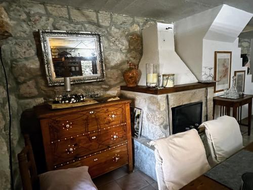 Zimmer mit Kamin, Kommode und Spiegel in der Unterkunft Villa Mali Jardin in Grižane