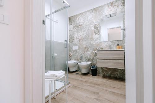 a bathroom with two toilets and a glass shower at PRIMO RENT ROOM in Mesagne