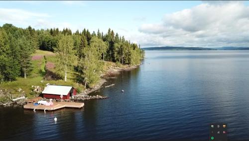 an aerial view of a house on a dock on a lake at Simple charming Double-room close to nature in Hillsand