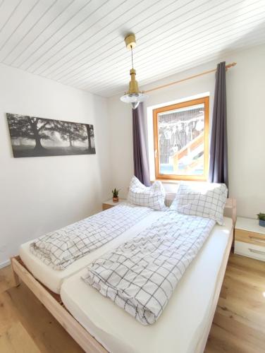 a bedroom with two beds and a window at Appartments am Waldbad - Unterm Nussbaum in Rassing