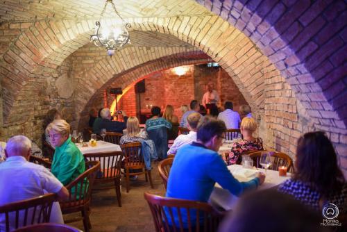 un grupo de personas sentadas en mesas en un restaurante en Hotel Zajazd Kultury, dawniej Pocztowy, en Zielona Góra