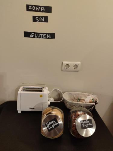 a kitchen with a toaster and a bowl of food at Hotel la posada de Numancia in Garray