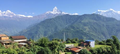 a village in a valley with mountains in the background at KB'S ECO MOUNTAIN VILLAGE HOME in Kāskī