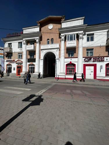 a building with a clock on the front of it at Location, locaton, location! in Ulaanbaatar