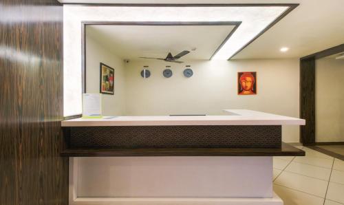 a bathroom with a sink and a mirror at Itsy By Treebo - N Square in Vijayawāda