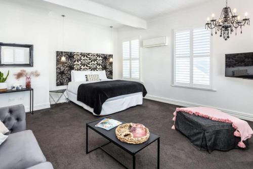 a bedroom with a bed and a living room at Altitude Studio Apartment in Martinborough 
