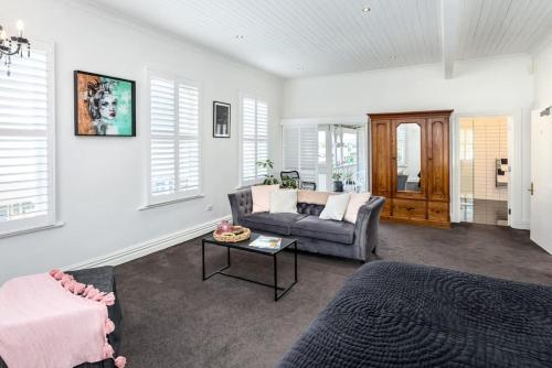 a living room with a couch and a table at Altitude Studio Apartment in Martinborough 
