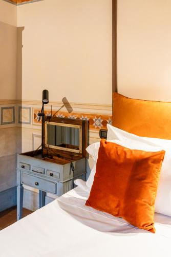 a bedroom with a bed with a television on a table at Castello di Limatola in Limatola