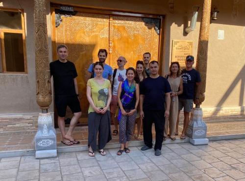 a group of people standing in front of a building at Khiva Siyovush Hotel in Khiva