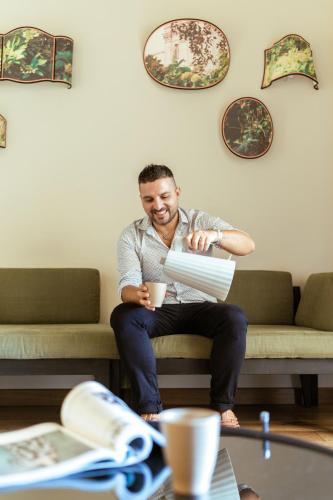 a man sitting on a couch holding a box at Condominio Monti Boutique Hotel in Rome