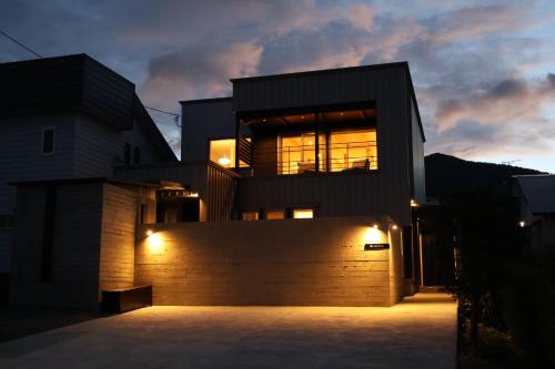 a large house with lights on the side of it at AKATSUKI in Furano