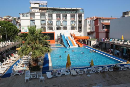 a swimming pool with a slide in a hotel at Ozkaptan Aqua Otel in Marmara
