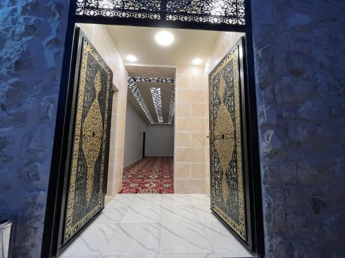 an entrance to a room with a door with ornamental tiles at Mansi Residence in Wadi Musa