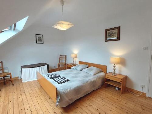 a bedroom with a large bed and a staircase at Maison familiale bord de mer in Douarnenez