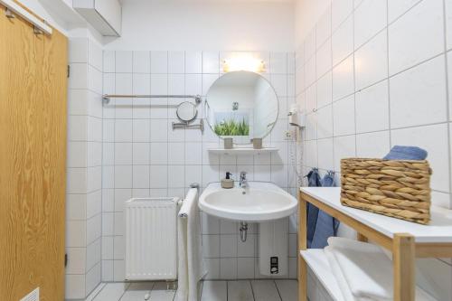 a white bathroom with a sink and a mirror at LM3-32 - Ferienwohnung Typ AB Komfort in Schottwarden