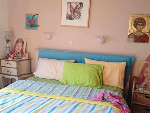 a bedroom with a bed and pictures on the wall at To spiti tis Xaras in Agia Anna
