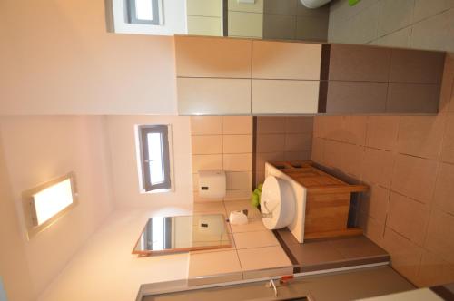 a small bathroom with a toilet and a window at Vasarely Luxury Flat in Satu Mare