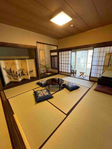 a room with a table and chairs in a room at Aioi Yanto 一日一組限定古民家宿 in Otaru