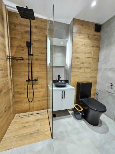 een badkamer met een douche, een toilet en een wastafel bij Rea Home Apartment in Sofia