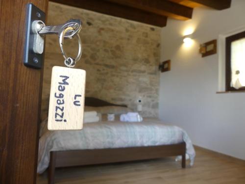 a room with a bed with a tag on a door at La Fattoria dei Sibillini in Montemonaco