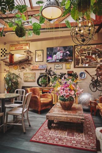 a living room with a table with flowers on it at The Legacy by 2GO4 City Center in Brussels