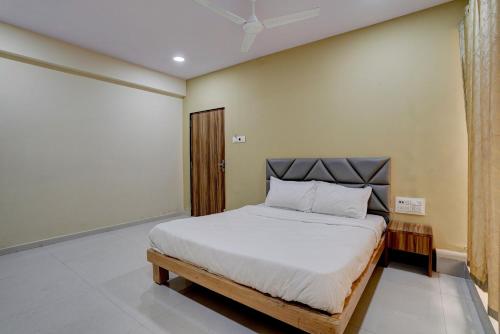 a bedroom with a large bed in a room at OYO Hotel 7 Star in Surat