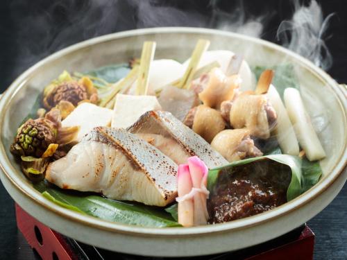 a bowl of food with meat and vegetables on a table at Kifuno Sato in Mimasaka
