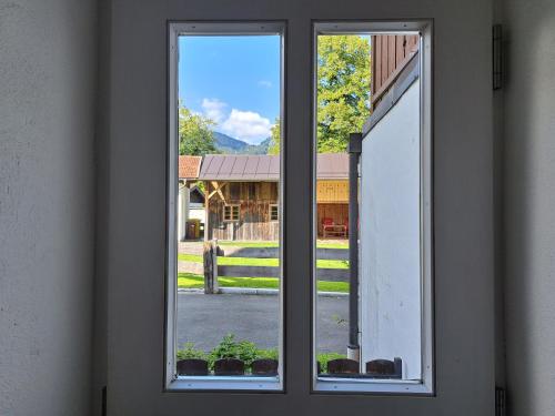 an open window with a view of a barn at Ferienwohnungen im Lüftlmalereck, Mussldomahaus in Oberammergau