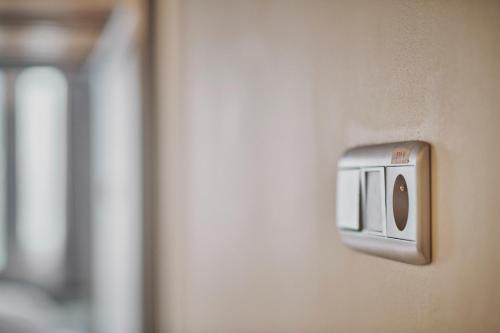 a lightswitch on the side of a wall at The Legacy by 2GO4 City Center in Brussels