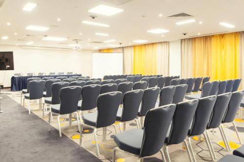 a conference room with chairs and a screen at Park Inn by Radisson Hotel Astana in Astana