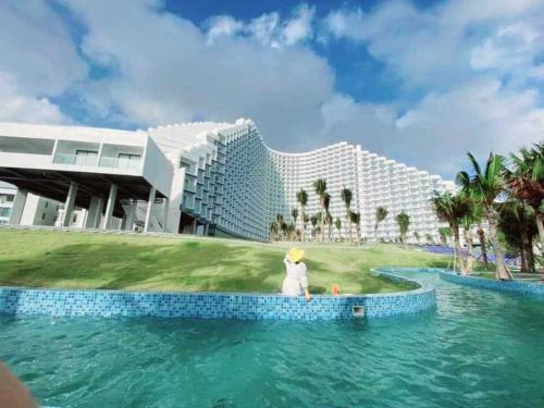 a rendering of a resort with a person in the water at Cam Ranh Nha Trang Seaview Resort in Cam Ranh