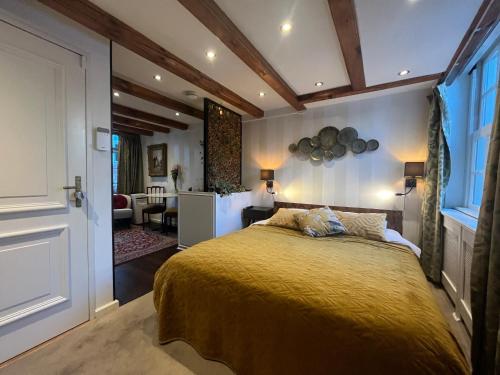 a bedroom with a bed and a living room at The Enlightened House Luxury Suites in Amsterdam