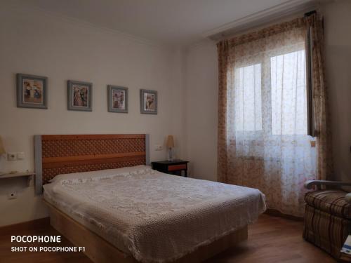 a bedroom with a bed and a window at La Mariña in Ribadeo